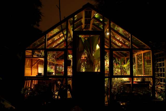 The greenhouse illuminated on a winters night.